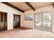 Bedroom with carpeted floors, wood beam ceiling, and sliding door to the deck at 5200 W Ottawa Ave, Littleton, CO 80128