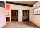 Bedroom with wood beam ceiling and two closet doors at 5200 W Ottawa Ave, Littleton, CO 80128