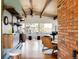 Sunlit living room with hardwood floors, exposed beams, large windows, and curated decor at 5200 W Ottawa Ave, Littleton, CO 80128