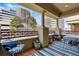 Cozy balcony area with comfortable seating and views of the cityscape with architectural columns at 40 Madison St # 203, Denver, CO 80206