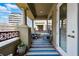 Inviting balcony featuring a blue and white rug, seating, and city views with architectural columns at 40 Madison St # 203, Denver, CO 80206