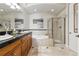 Elegant bathroom with double vanity, soaking tub, and a separate glass enclosed shower at 40 Madison St # 203, Denver, CO 80206