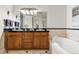 Elegant bathroom with double vanity, soaking tub, and a separate glass enclosed shower at 40 Madison St # 203, Denver, CO 80206