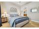 Bright bedroom featuring a comfortable bed, stylish decor, and an ensuite bathroom at 40 Madison St # 203, Denver, CO 80206
