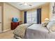 Comfortable bedroom with large window providing natural light and neutral tones for relaxation at 40 Madison St # 203, Denver, CO 80206