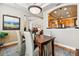 Dining room featuring hardwood floors, neutral walls, modern lighting, and open to other rooms at 40 Madison St # 203, Denver, CO 80206