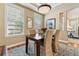 Dining room with hardwood floors and natural light, features a wooden table and neutral walls at 40 Madison St # 203, Denver, CO 80206