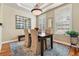 Dining room features hardwood floors, neutral walls, modern lighting, and a wooden table and chairs at 40 Madison St # 203, Denver, CO 80206