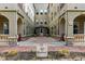Condo exterior with lovely architecture featuring a landscaped courtyard leading to the main entrance at 40 Madison St # 203, Denver, CO 80206
