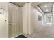 Bright hallway with carpet and detailed trim showcasing the unit's entrance at 40 Madison St # 203, Denver, CO 80206