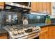 Close-up of stainless steel range with black countertop and wood cabinets above at 40 Madison St # 203, Denver, CO 80206