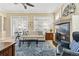 Cozy living room with a beautiful fireplace, plush seating, and ample natural light at 40 Madison St # 203, Denver, CO 80206