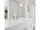 Bathroom features a modern vanity, a large mirror, and a shower with white tile at 1284 Quitman St, Denver, CO 80204