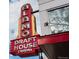 Brightly lit Alamo Draft House Cinema sign with red trim at 1284 Quitman St, Denver, CO 80204