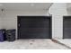 Detached two-car garage with a modern black door and gray siding at 1284 Quitman St, Denver, CO 80204
