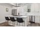 Modern kitchen featuring stainless steel appliances, a sleek island, and bar seating at 1284 Quitman St, Denver, CO 80204