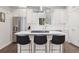 Stylish kitchen featuring stainless steel appliances, an island with bar stools, and modern finishes at 1284 Quitman St, Denver, CO 80204