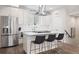 Modern kitchen features an island, stainless steel appliances, white cabinetry, and wood floors at 1284 Quitman St, Denver, CO 80204