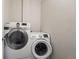 Modern laundry room featuring a stacked washer and dryer in white at 1284 Quitman St, Denver, CO 80204