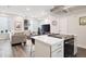Open-concept living room and kitchen area with modern appliances and neutral tones at 1284 Quitman St, Denver, CO 80204