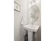 Stylish powder room featuring pedestal sink and elegant fixtures at 1284 Quitman St, Denver, CO 80204