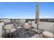 Outdoor rooftop patio area featuring chairs, an umbrella, and open views at 1284 Quitman St, Denver, CO 80204