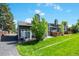 A long and grassy backyard with a small patio and a well manicured lawn at 5415 W 16Th Ave, Lakewood, CO 80214