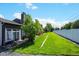 A well maintained backyard with a patio and a strip of green grass between houses at 5415 W 16Th Ave, Lakewood, CO 80214