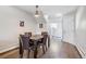 Inviting dining room with hardwood floors, a modern light fixture, and a view of the staircase at 5415 W 16Th Ave, Lakewood, CO 80214