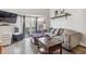 Cozy living room features a comfortable gray couch, stylish decor, and ample natural light from the sliding doors at 5415 W 16Th Ave, Lakewood, CO 80214