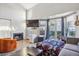 Bright living room with a fireplace, high ceilings, and sliding glass doors to a backyard patio at 5415 W 16Th Ave, Lakewood, CO 80214