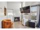 Bright living room featuring a fireplace, large window, and modern furnishing, offering a cozy and inviting atmosphere at 5415 W 16Th Ave, Lakewood, CO 80214