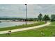 A scenic view of a park next to the lake with geese and a walking path at 5415 W 16Th Ave, Lakewood, CO 80214