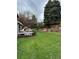 Large, manicured backyard with a deck, seating area, and mature trees offering ample shade at 8503 E Jamison Ave, Centennial, CO 80112