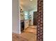 Small bar with wooden floors, beverage cooler, and shelving for bottles and glassware at 8503 E Jamison Ave, Centennial, CO 80112