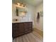 Bathroom features a dark wood vanity, marble countertop, and bright subway tile at 8503 E Jamison Ave, Centennial, CO 80112