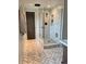 Modern bathroom featuring a glass-enclosed shower with neutral tile and herringbone-patterned tile flooring at 8503 E Jamison Ave, Centennial, CO 80112
