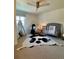 Cozy bedroom with a crib, a teepee, a modern ceiling fan, and carpeted floors for a calming atmosphere at 8503 E Jamison Ave, Centennial, CO 80112