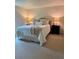 Bright bedroom with neutral walls, two side tables with lamps, and a comfortable bed with many pillows at 8503 E Jamison Ave, Centennial, CO 80112