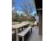 Outdoor deck area with dining table and seating, set in a lush backyard with mature trees at 8503 E Jamison Ave, Centennial, CO 80112