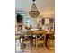 Elegant dining room with skylights, large wood table, and beaded chandelier at 8503 E Jamison Ave, Centennial, CO 80112
