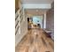 Inviting entryway with wood floors, brick accent wall, stairs, and open view to living area at 8503 E Jamison Ave, Centennial, CO 80112
