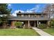 Charming two-story home with brick accents, shutters, manicured lawn, and covered porch at 8503 E Jamison Ave, Centennial, CO 80112