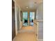 Hallway leading to bedrooms with carpeted floors, white trim, shiplap walls, and neutral decor at 8503 E Jamison Ave, Centennial, CO 80112