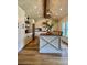 Bright kitchen with white cabinets, wood island countertop, and modern pendant lighting at 8503 E Jamison Ave, Centennial, CO 80112