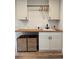 This laundry room features modern cabinets, a butcher block countertop, and wooden floors at 8503 E Jamison Ave, Centennial, CO 80112