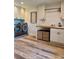 Bright laundry room featuring modern washer/dryer, wood countertops, and stylish cabinets with wooden floors at 8503 E Jamison Ave, Centennial, CO 80112