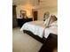 Bedroom features a ceiling fan, a comfortable bed with white bedding, and dark wood furniture, creating a relaxing space at 8503 E Jamison Ave, Centennial, CO 80112