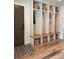 Welcoming mudroom with built-in storage cubbies, bench seating, and hooks for organization at 8503 E Jamison Ave, Centennial, CO 80112