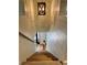 View down the staircase with wooden steps and white shiplap walls at 8503 E Jamison Ave, Centennial, CO 80112
